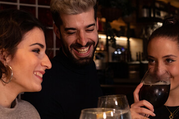 Friends enjoy themselves at a bar while having a drink, the atmosphere is youthful and fun.