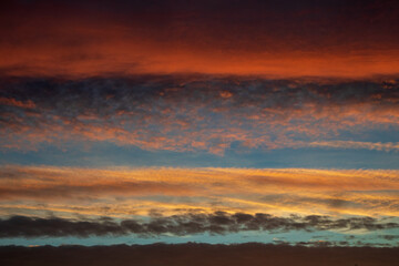 Sunrise with orange sky and colourful clouds