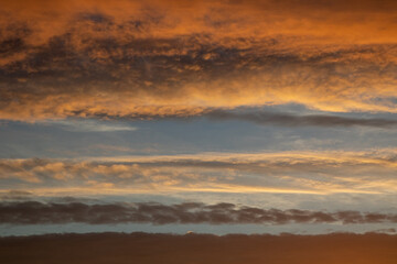 Fototapeta na wymiar Sunrise with orange sky and colourful clouds