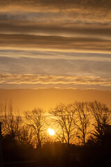 Fototapeta na wymiar Sunrise with orange sky and colourful clouds