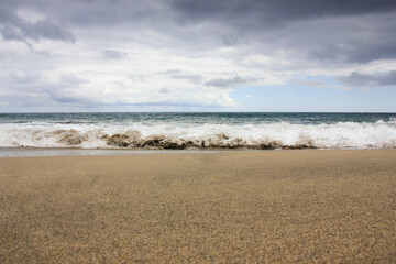 Breaking wave, light sand, Azores, Santa Maria island.