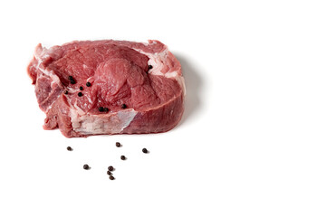 Raw meat and black pepper on a white background Close-up Source of protein Nutrition for athletes