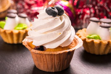 Cupcakes on the background of New Year's decorations