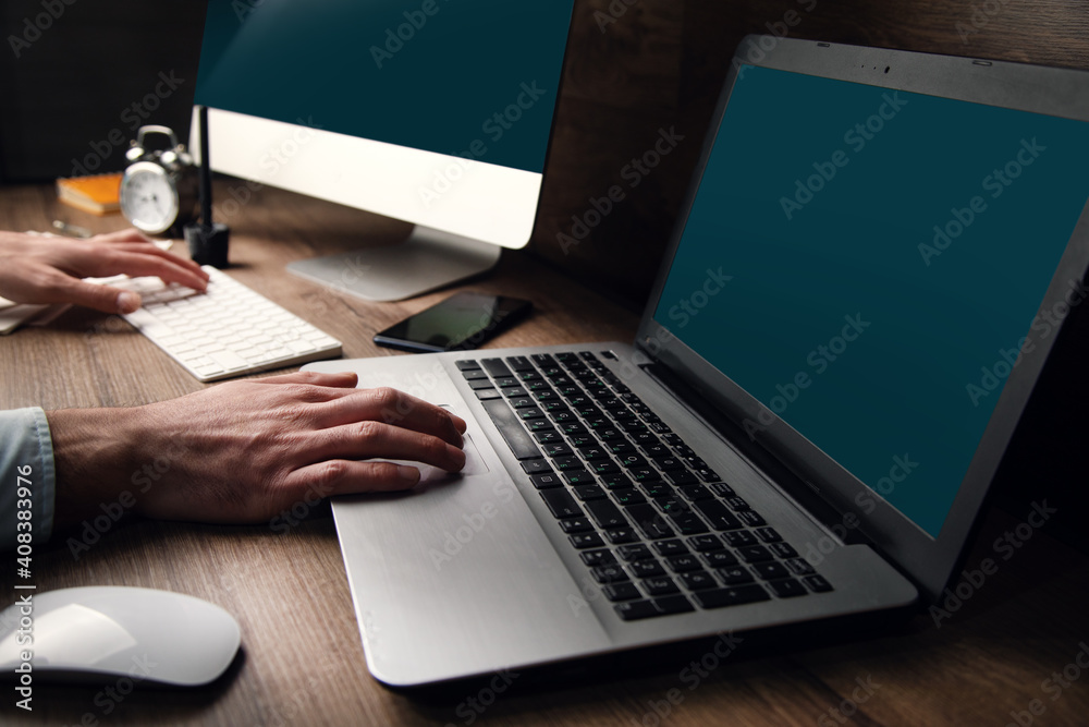 Wall mural business man working two computers