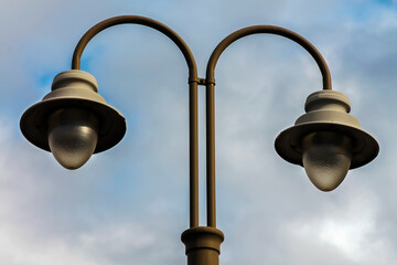Street lamp and blue sky and white clouds on background