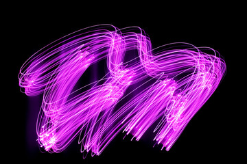 Long exposure pink lights abstract texture background. Pink lights drawing patterns on black background.