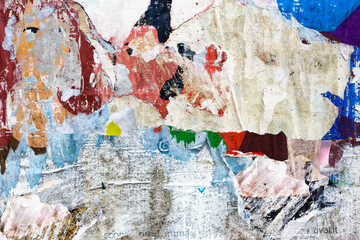 Fototapeta premium Old torn, ruined and crumpled street poster. Urban background