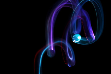 Long exposure colorful lights abstract texture background. Colorful lights drawing patterns on black background. Colored wallpaper.