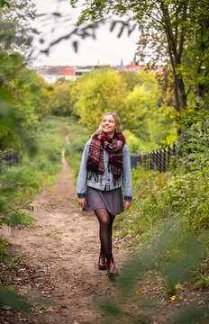 Young Woman Walking In Park During Autumn