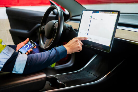 Mature male programmer using digital tablet in car
