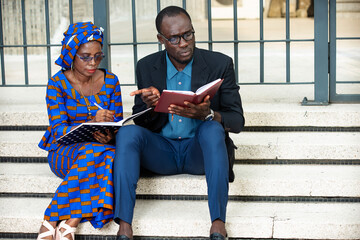 two adult business people in meeting outside.