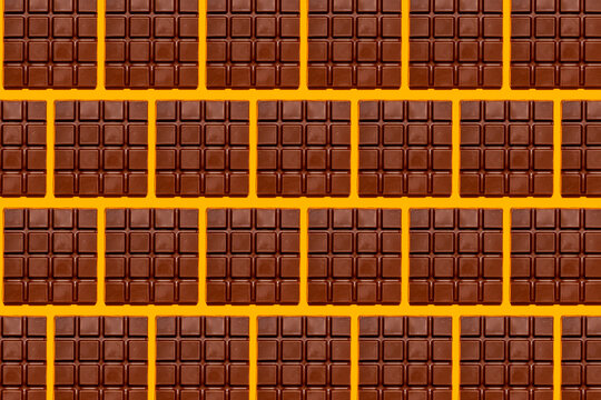 Pattern of chocolate bars against yellow background