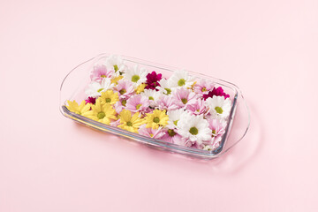Beautiful flowers in a baking dish filled with water.