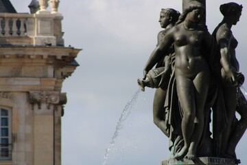 Women sculpture raining the world