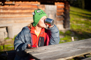 The tourist girl drinks tea.