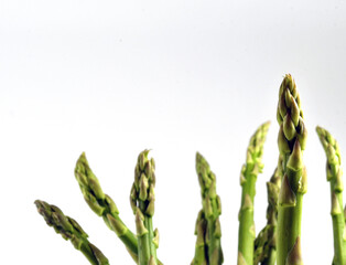 Close up view of fresh asparagus spears. standing vertically. No people. Plain white background....