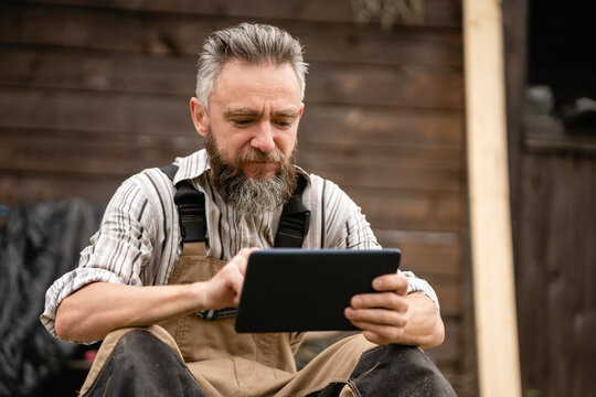 Portrait of carpenter using digital tablet during break