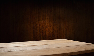 Selected focus empty brown wooden table and wall texture or old black brick wall blur background image. For your installation or product demonstration