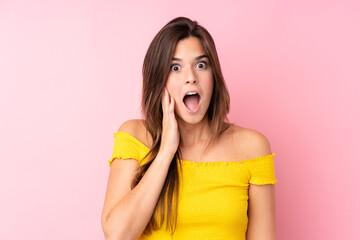 Fototapeta na wymiar Teenager Brazilian girl over isolated pink background with surprise and shocked facial expression