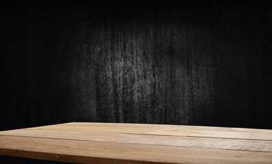 Selected focus empty brown wooden table and wall texture or old black brick wall blur background image. For your installation or product demonstration