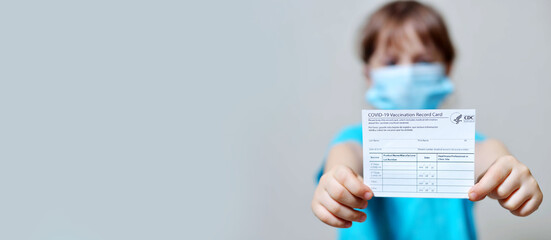 banner girl is holding a vaccination record card and corona virus vaccine vials. Passport of...