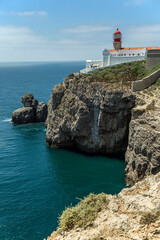 Fototapeta na wymiar Rocky Coastline And Lighthouse At Cabo De Sao Vicente, Algarve, Portugal, Europe