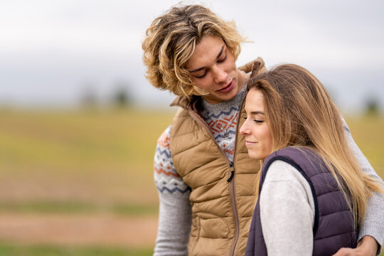 Brother and sister embracing outdoors during hike