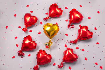 One yellow and many small red Air Balloons of heart shaped foil