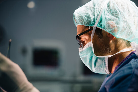 Male orthopedic surgeon performing operation in emergency room