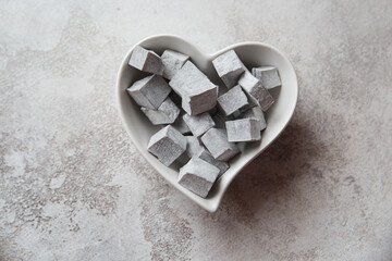 Turkish delight. Turkish sweets in a heart-shaped plate. lokum.Grey colour. Valentine's day concept. Background image for design