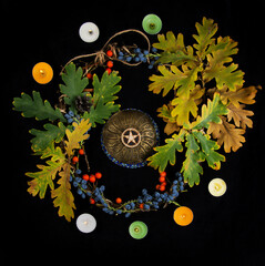 Wiccan pentacle with dried leafs and wreath