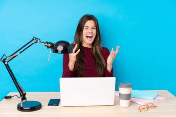Teenager Brazilian girl with a laptop in a table unhappy and frustrated with something