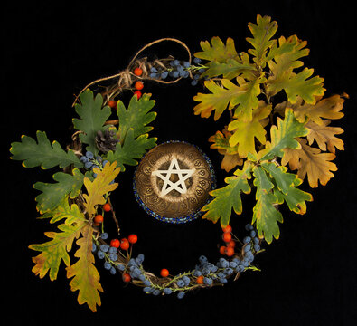 Wiccan pentacle with dried leafs and wreath