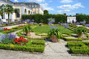 Botanical garden with flower beds with colorful flowers and small paths for admirers