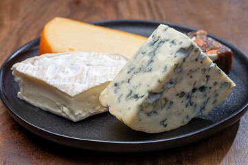 Cheese collection, blue cheese, camembert, brie served as dessert with fig almonds bread