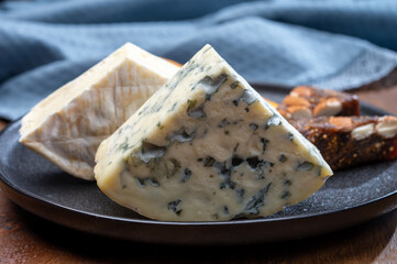 Cheese collection, blue cheese, camembert, brie served as dessert with fig almonds bread