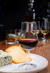 Tasting and pairing of different cheeses with strong alcoholic drinks, whisky, cognac or calvados