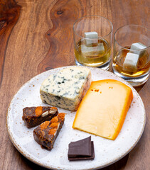 Tasting and pairing of different cheeses with strong alcoholic drinks, whisky, cognac or calvados