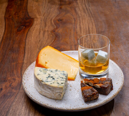 Tasting and pairing of different cheeses with strong alcoholic drinks, whisky, cognac or calvados