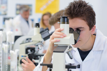 young man and a microscope