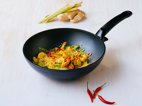 Fried curry with prawns and vegetables in wok