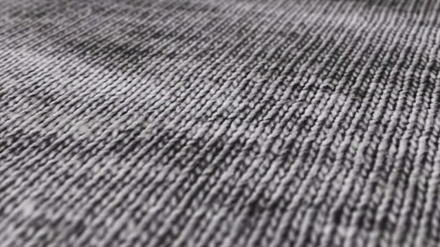 Black and white burlap texture background macro shot. Detailed grey fabric cloth background with pan movement.