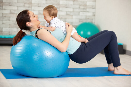 young woman and baby doing pilates