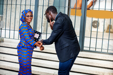 businesswoman and businessman holding hands.