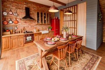 cozy all wooden interior of a country house in a wooden design. spacious living room with kitchen area with large windows. bedroom on the second floor.