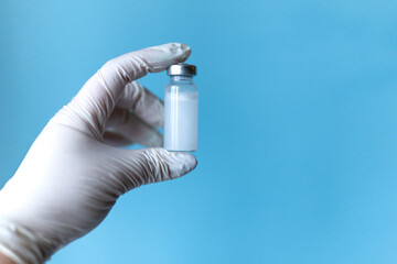 Doctor, nurse, scientist hand in white gloves holding coronavirus, covid-19 vaccine disease on blue...