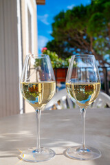 Tasting of local white wine on sunny summer balcony Provence, France
