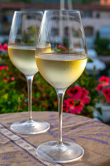 Tasting of local white wine in summer with sail boats haven of Port Grimaud on background, Provence, France