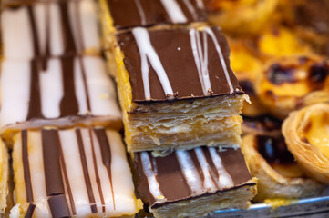 Traditional dessert pastry in Portugal, puff eggs cream cakes with chocolate
