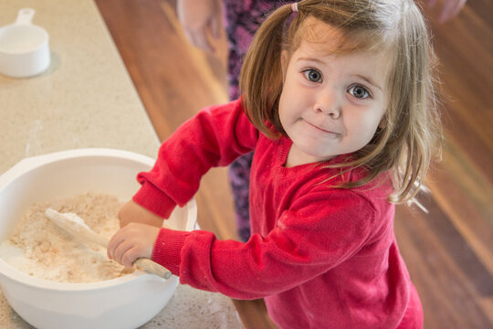 Little girl helping cook ANZAC biscuits